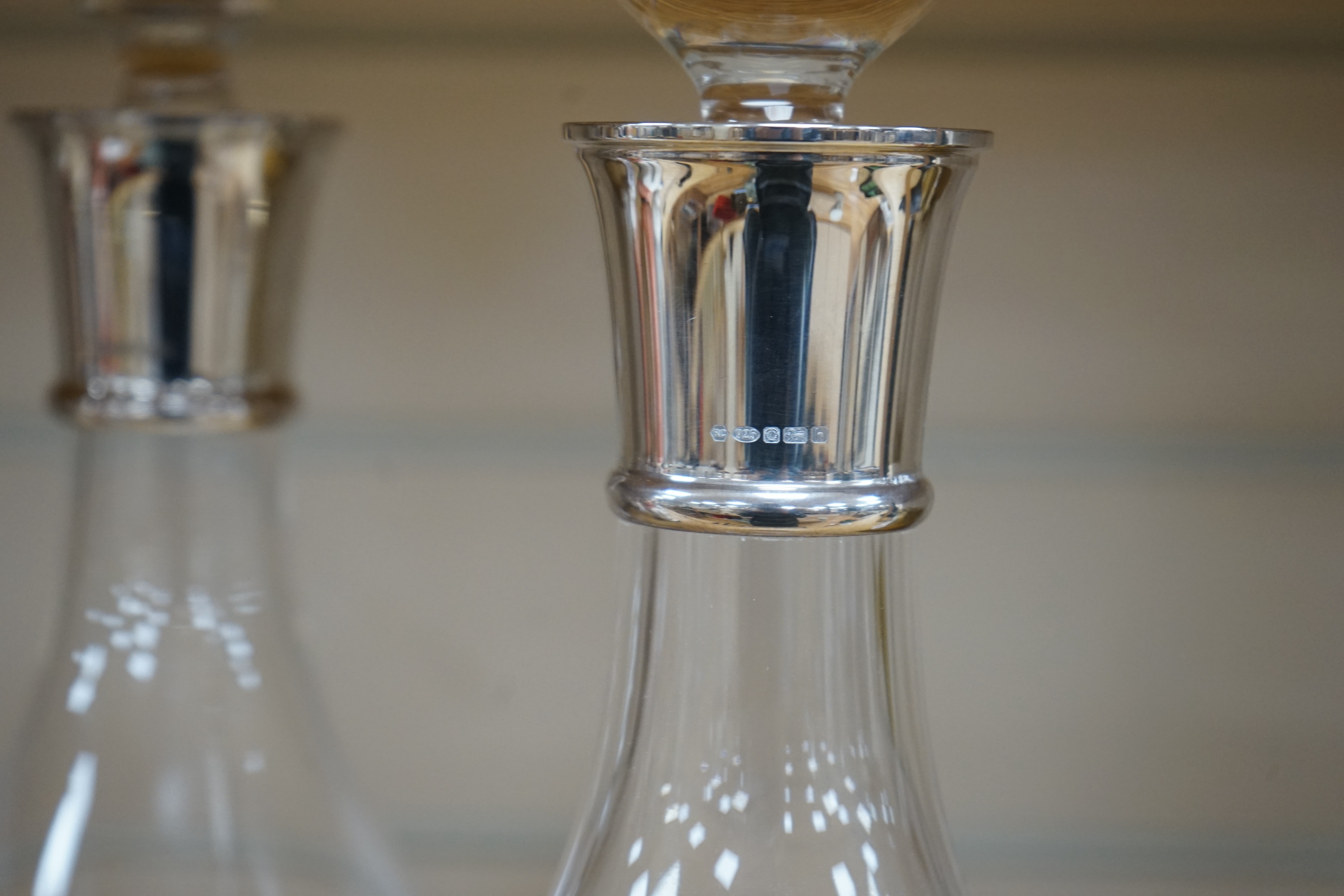 A pair of modern silver collared glass decanters and stoppers, 31cm. Condition - fair to good